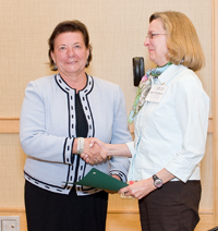 Laura Campbell presents Beth Sandore and the University of Illinois at Urbana-Champaign, an NDSA founding member, with a certificate. Credit: Barry Wheeler 